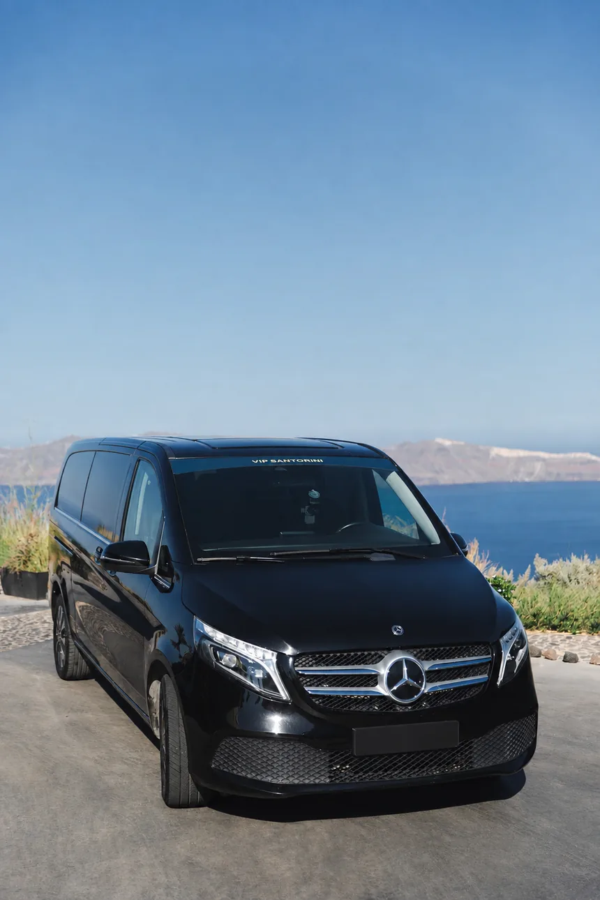 Mercedes V-Class private transfer vehicle above the Santorini caldera
