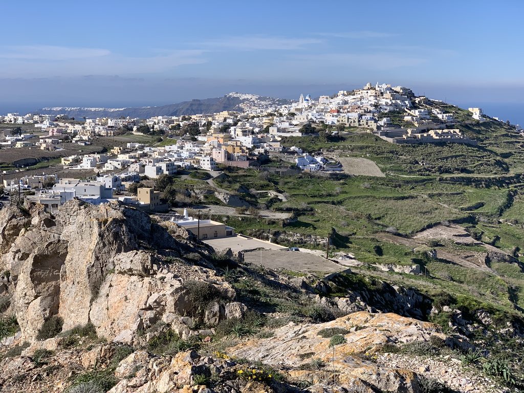 Pyrgos village on its hilltop in central Santorini, with terraced fields and the caldera rim behind
