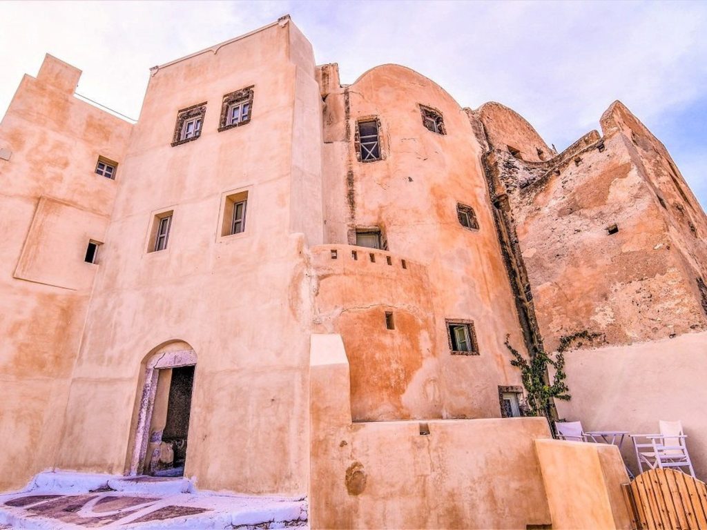 The ochre walls of the Kasteli, the Venetian castle quarter of Pyrgos village in Santorini